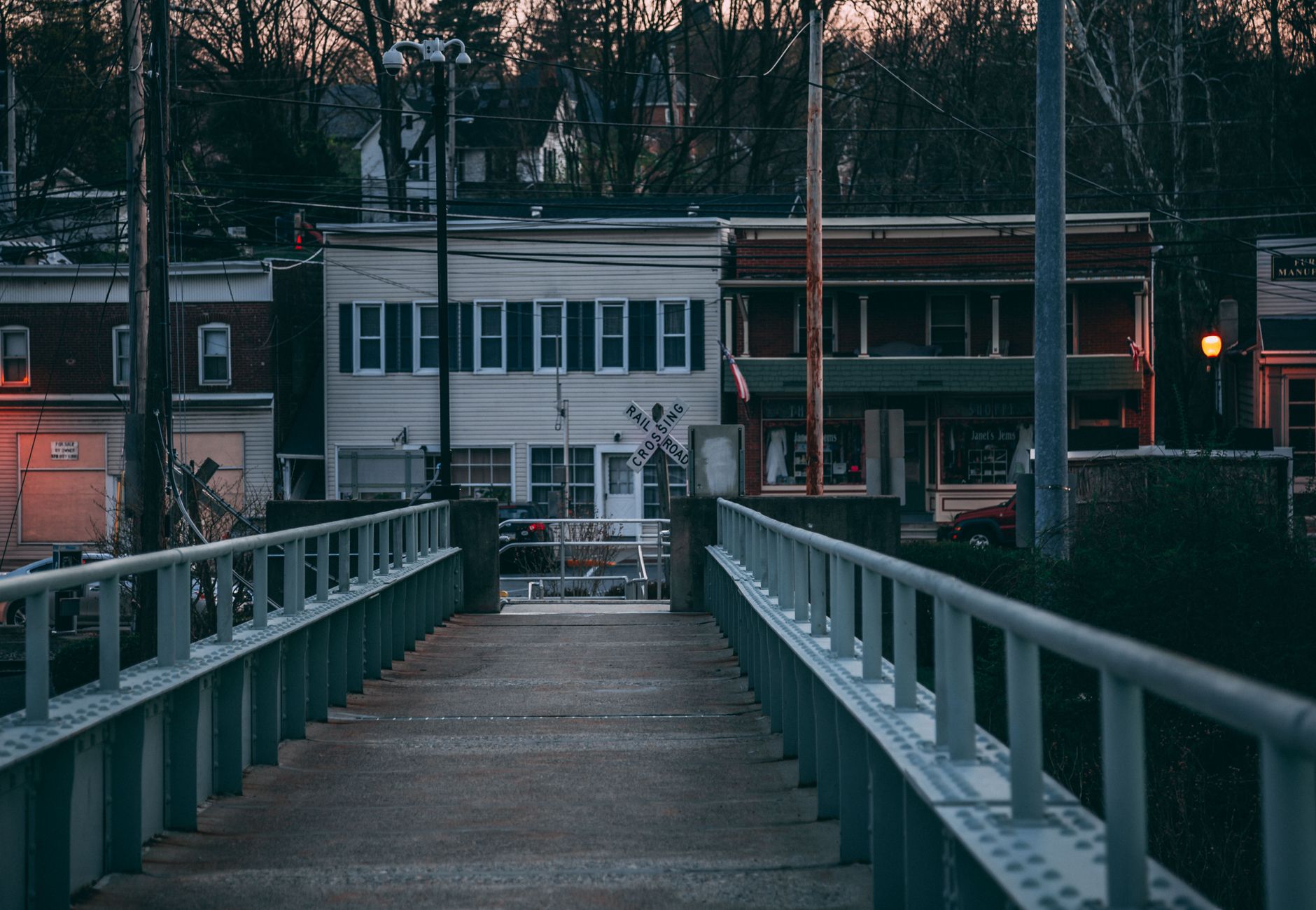 Atmospheric dusk view of a bridge leading to buildings in Portland, PA.